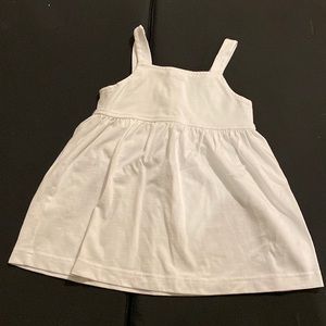 white flared tank with buttons in the back